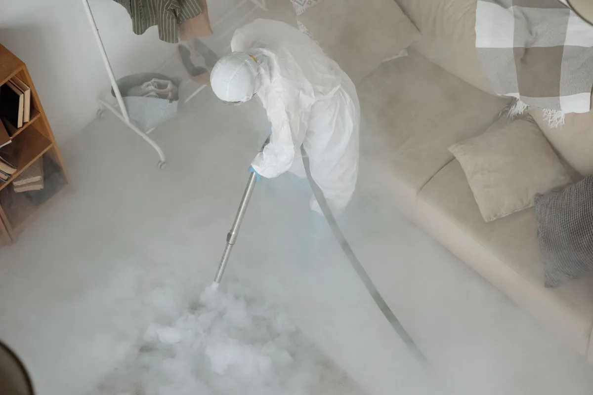 Biohazard cleanup technician in protective equipment, Kingman, KS